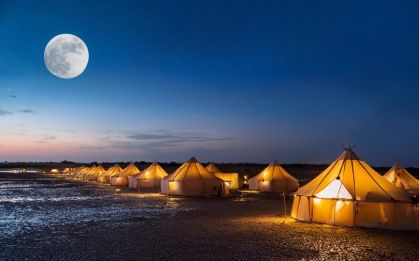 Couple watching a full-moon night over the White Rann from Dhordo Tent City, Kutch