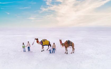 with tents lit at dusk beside the White Rann